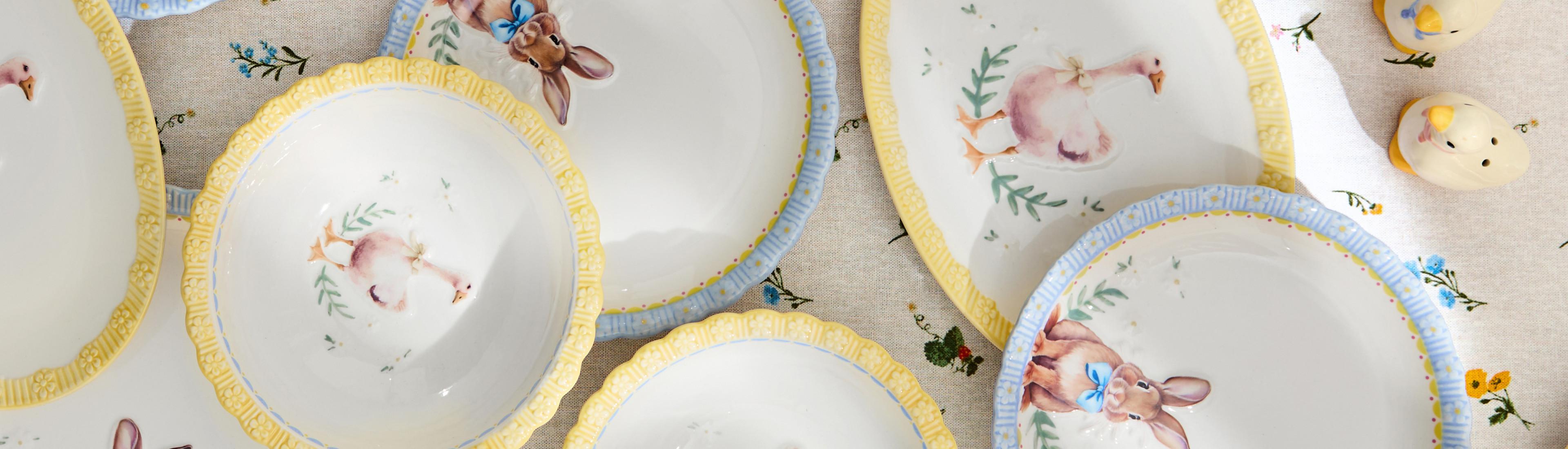 Dětské keramické vázy se žlutými lemy zdobí malovaní králíčci a kachny v pastelových barvách.