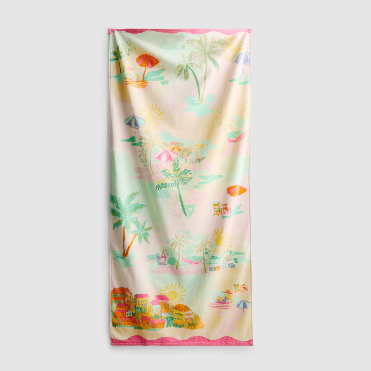 Colourful beach towel featuring tropical beach scene with palm trees, umbrellas, and coastal buildings.