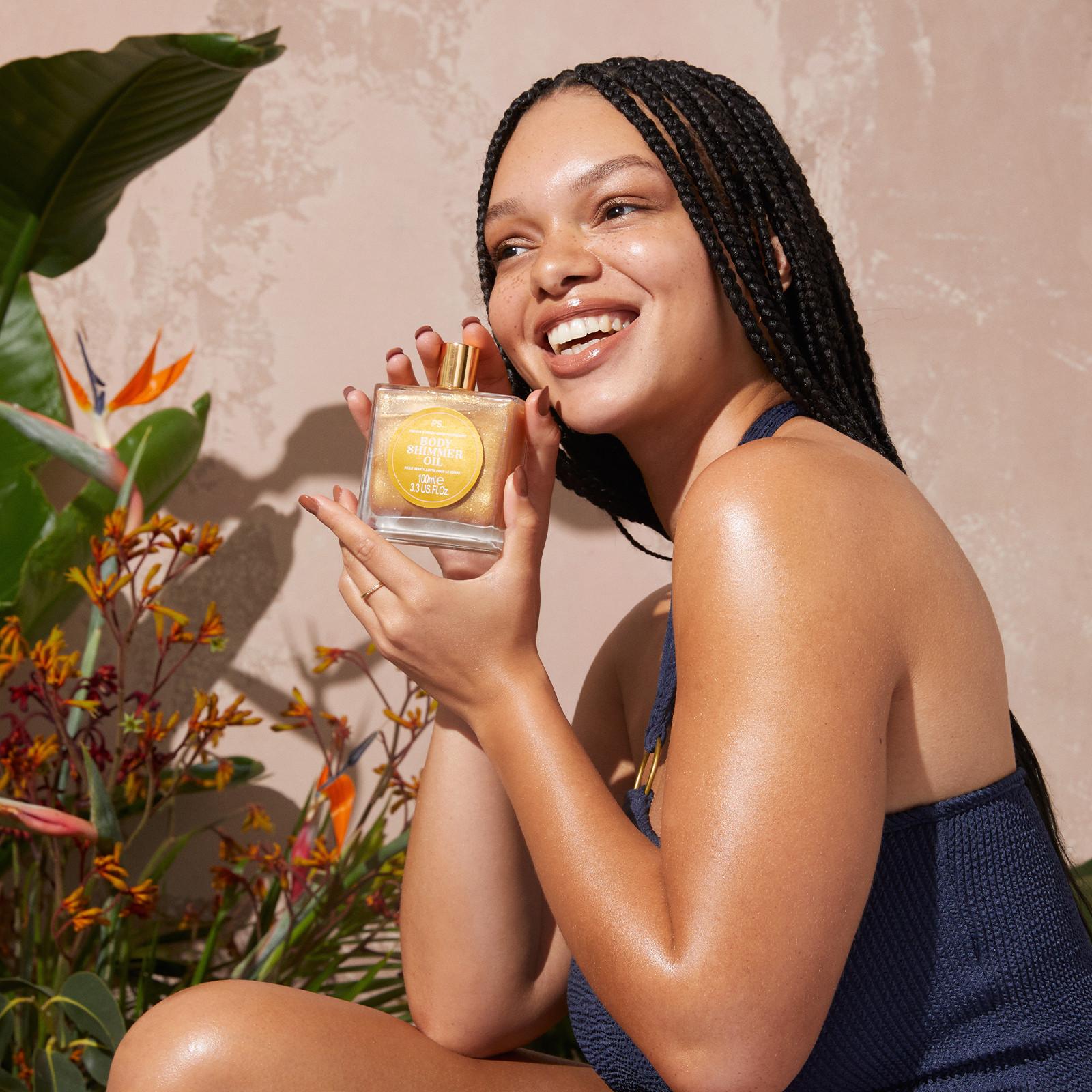 Woman holding bronzing oil