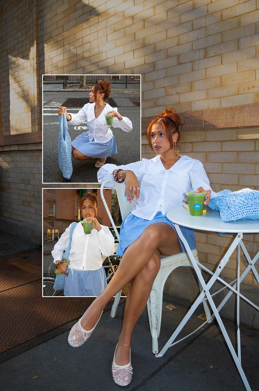 Model wearing a blue mini skirt with a white long sleeve shirt, paired with white ballet flats and a blue purse