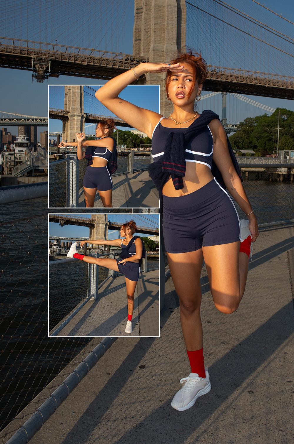 Model wearing navy blue activewear with red socks and white sneakers