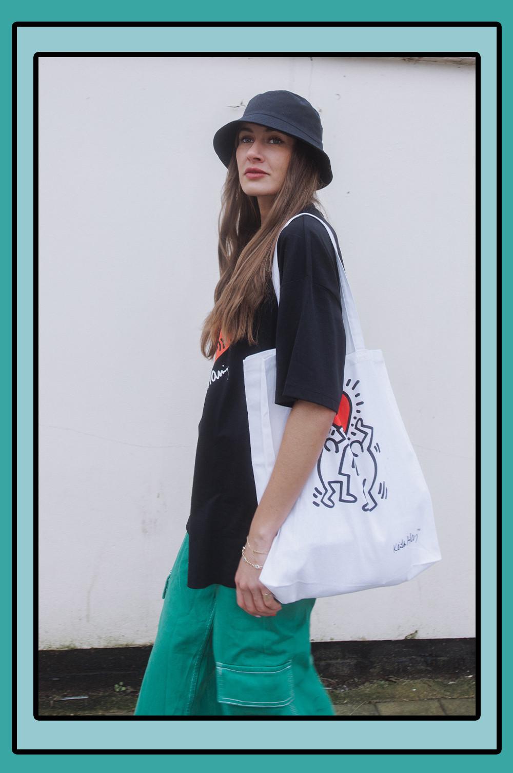 Model wears Keith Haring tote bag ad oversized black tshirt
