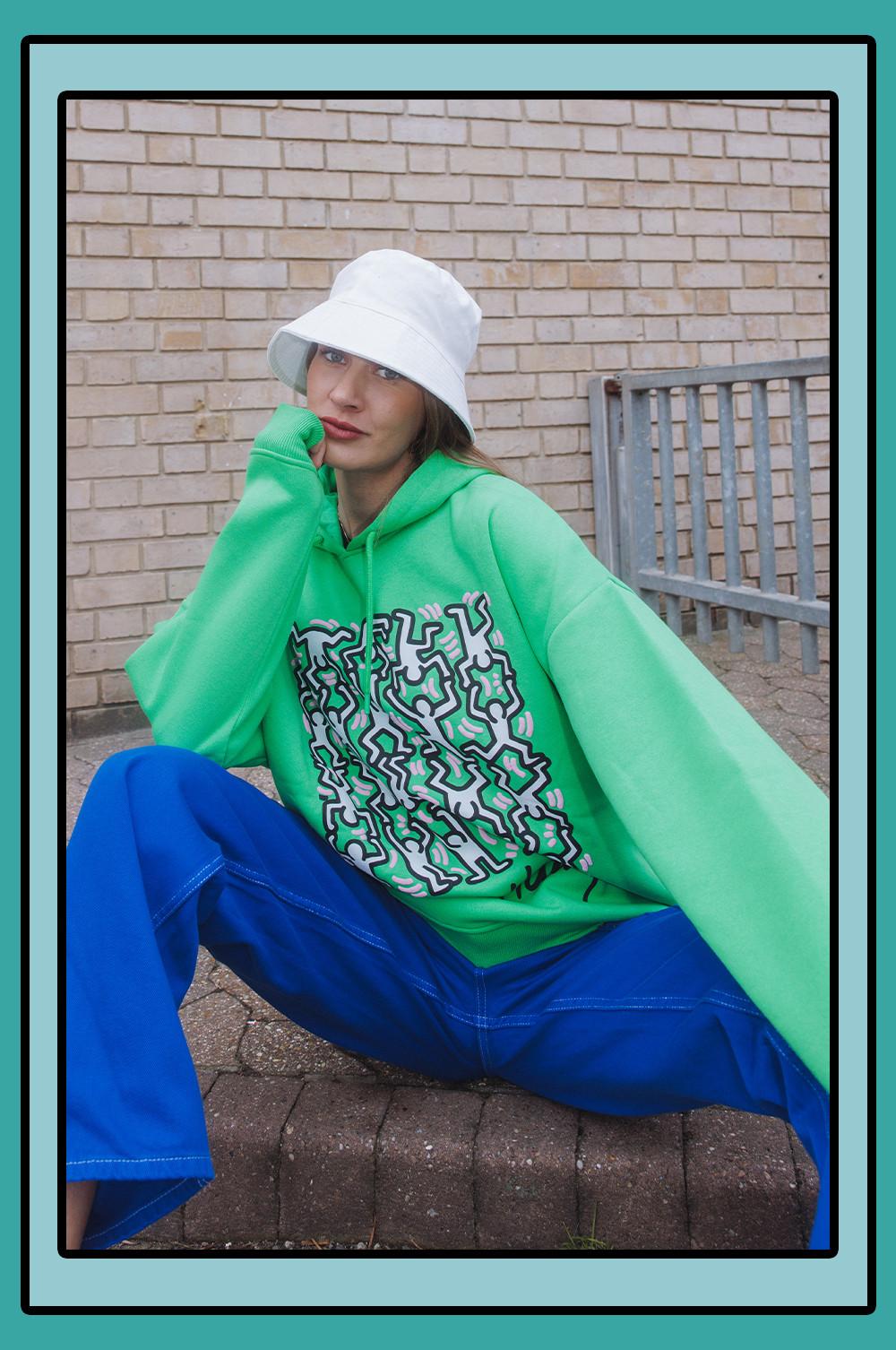 Model wears Green Keith Haring hoodie