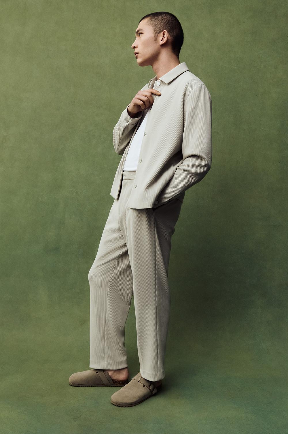 Model wearing a grey co-ord with clog shoes and white t-shirt