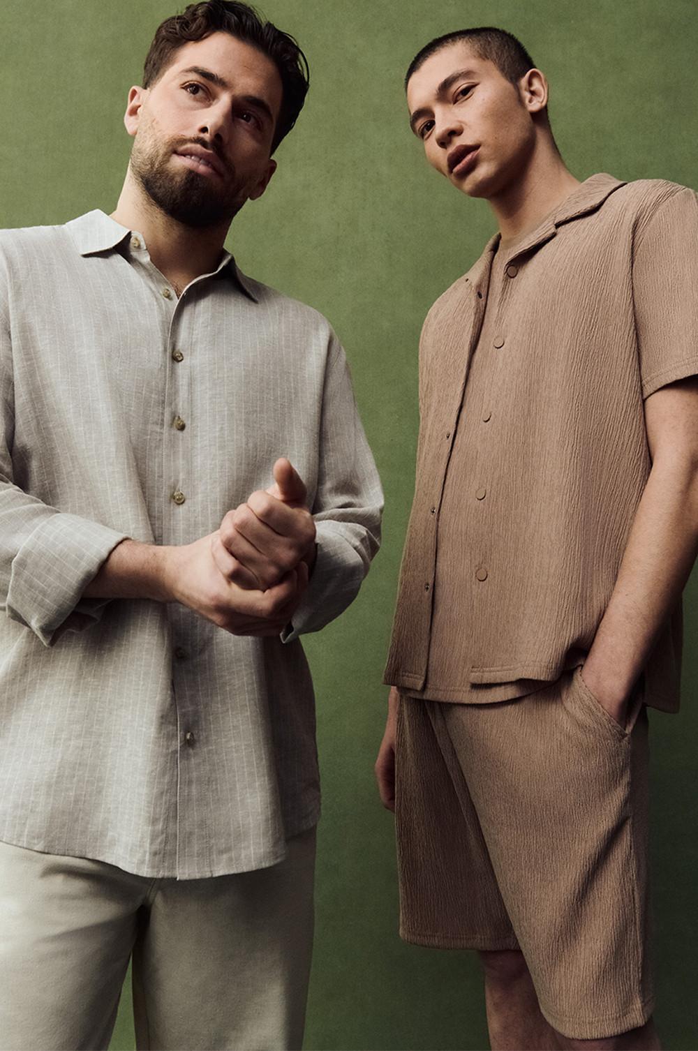 Kem and model in textured shirts, one beige with long sleeves, the other tan with shorts.