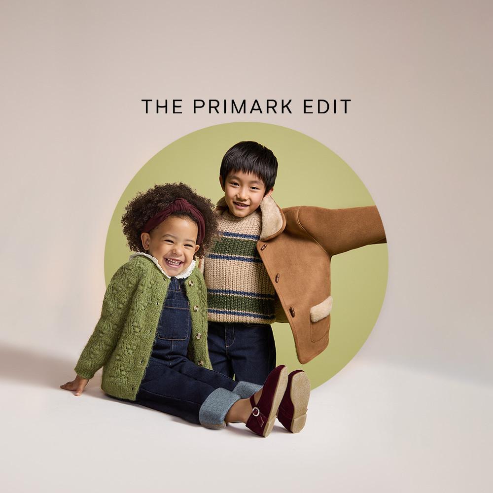 Two children wearing Primark autumn clothing including knitted jumpers, denim and coats against a pale green circular backdrop.