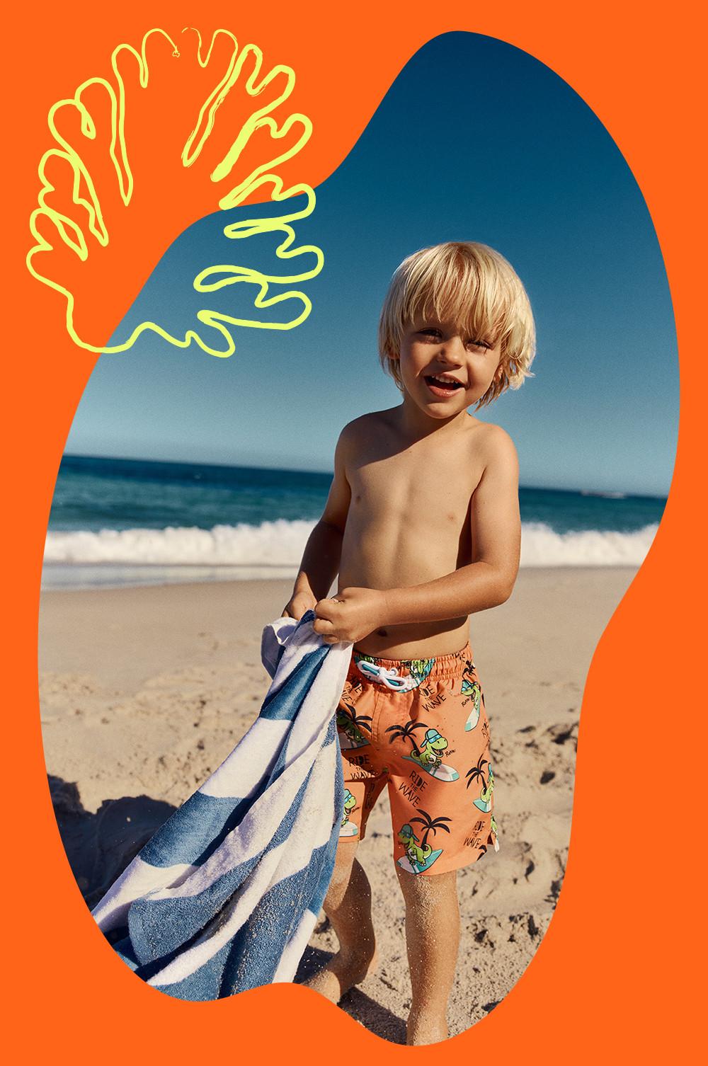 Child wears orange printed swim shorts