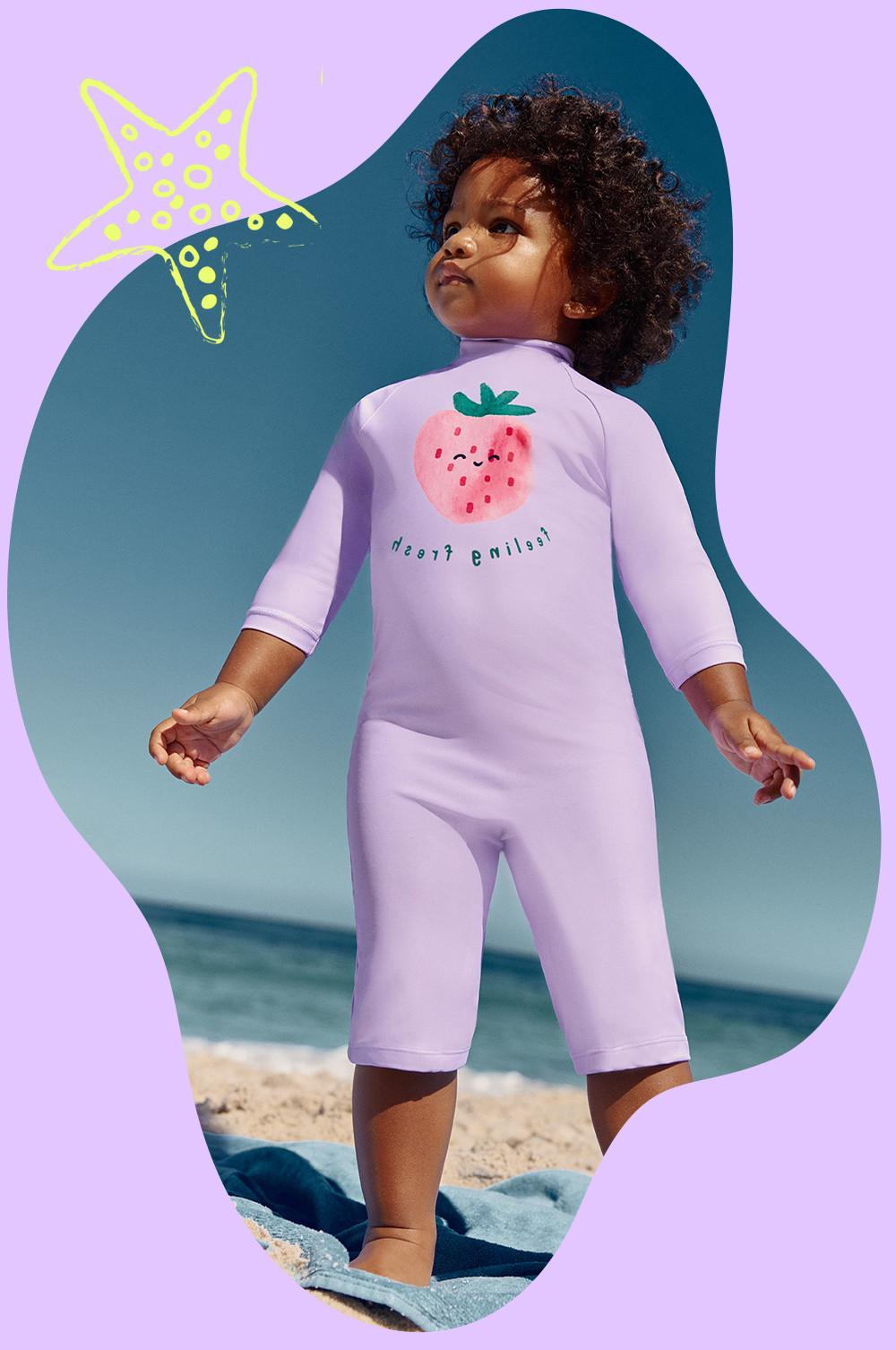 Child wears full length lilac wetsuit