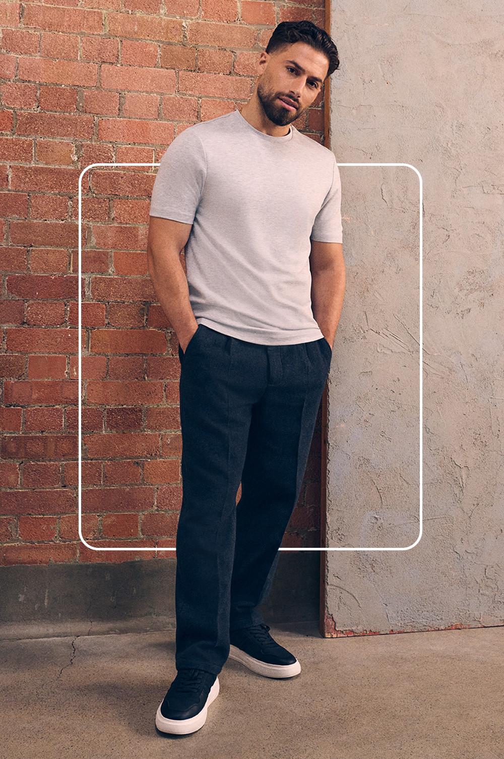 Kem wearing t-shirt, trousers and trainers