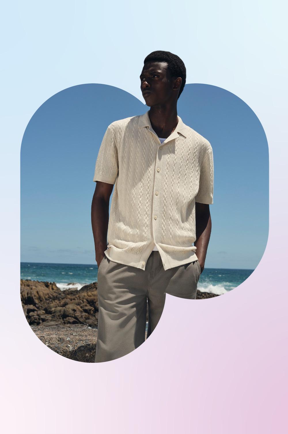 Model wearing a white shirt and grey trousers