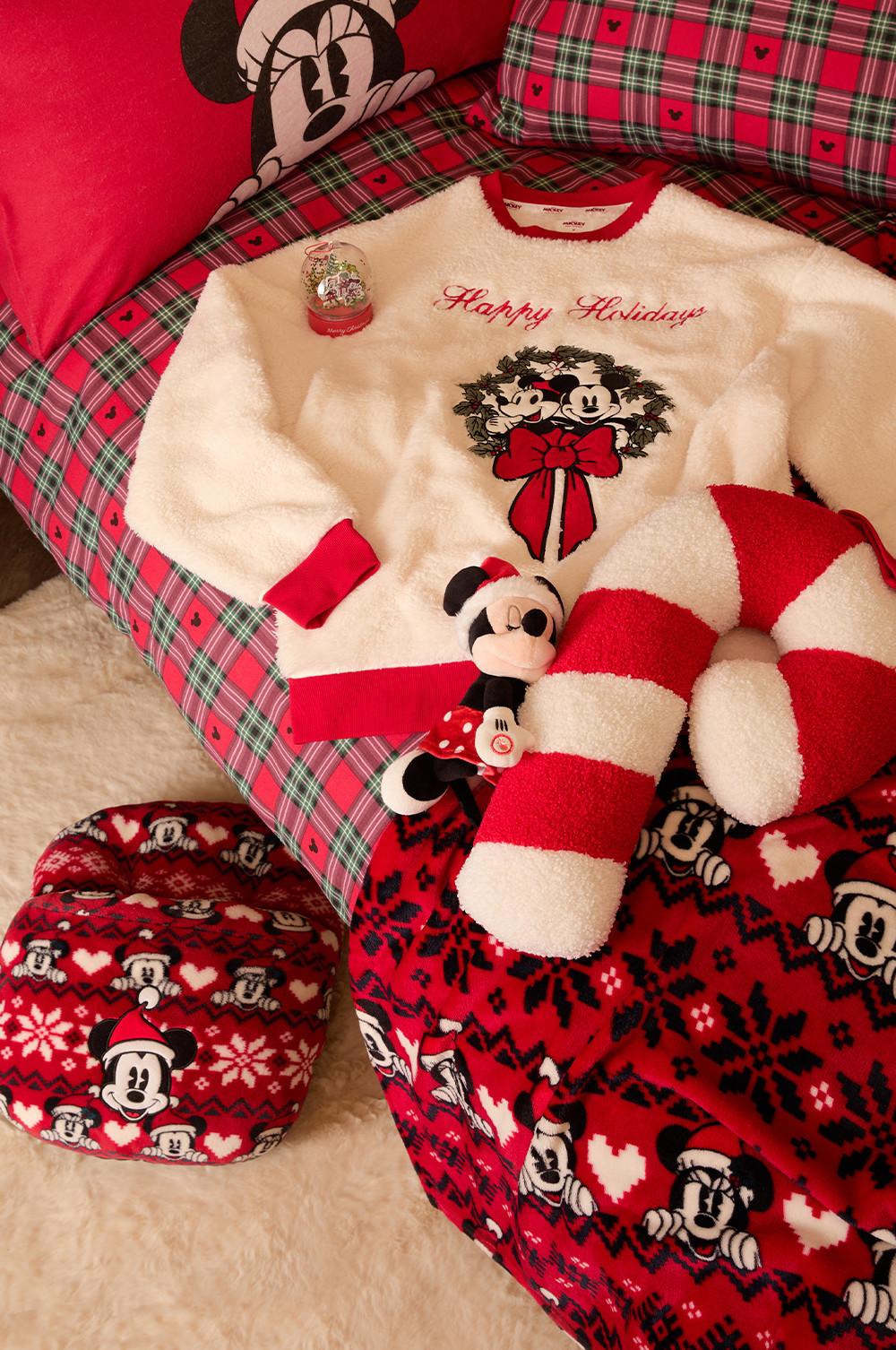 Disney Mickey Mouse Christmas collection featuring pajamas, plush toys and bedding in festive red tartan pattern.