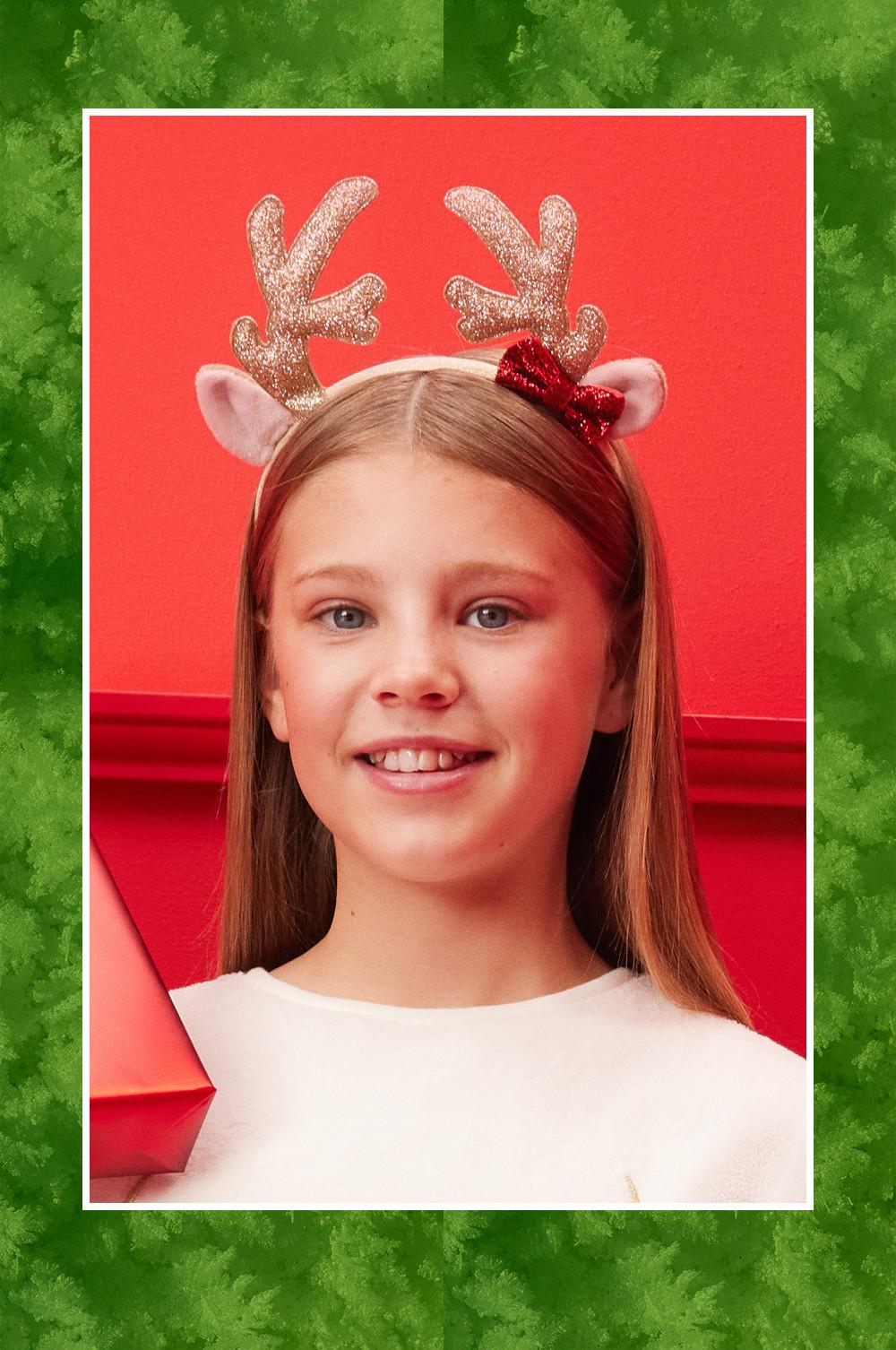 Child wears reindeer headband