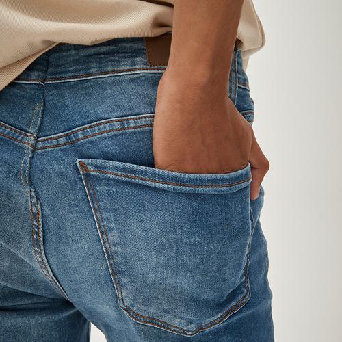 Close up of model wearing blue denim jeans