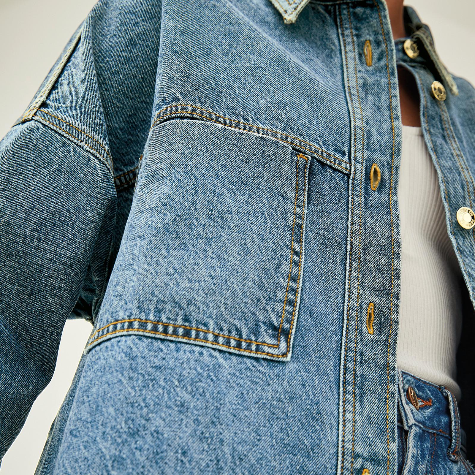 Close up of model wearing blue denim jeans