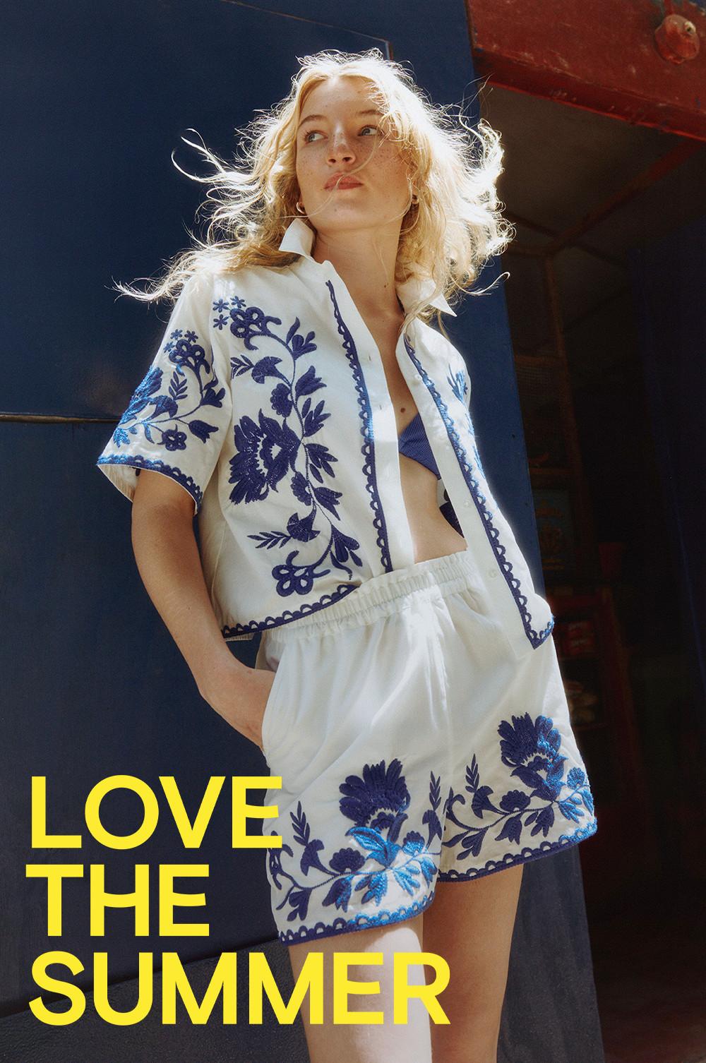 Model with the slogan "love the summer" in white and blue co-ord summery set