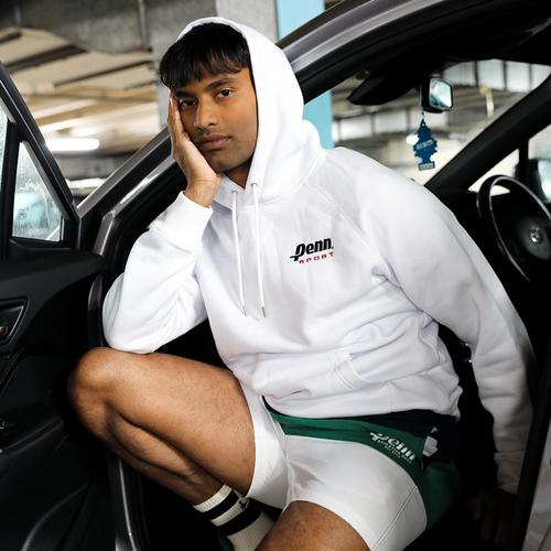 Model in a car wearing a white hoodie