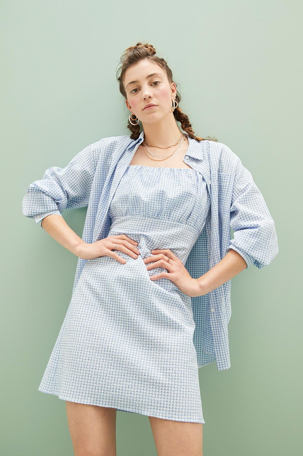 Model wearing blue gingham dress and shirt