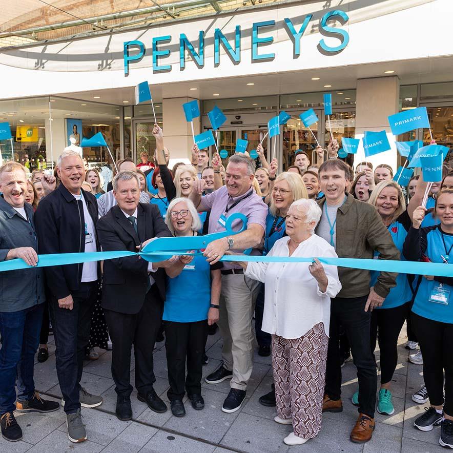 Penneys employees standing outside the Limerick store cutting the ribbon.