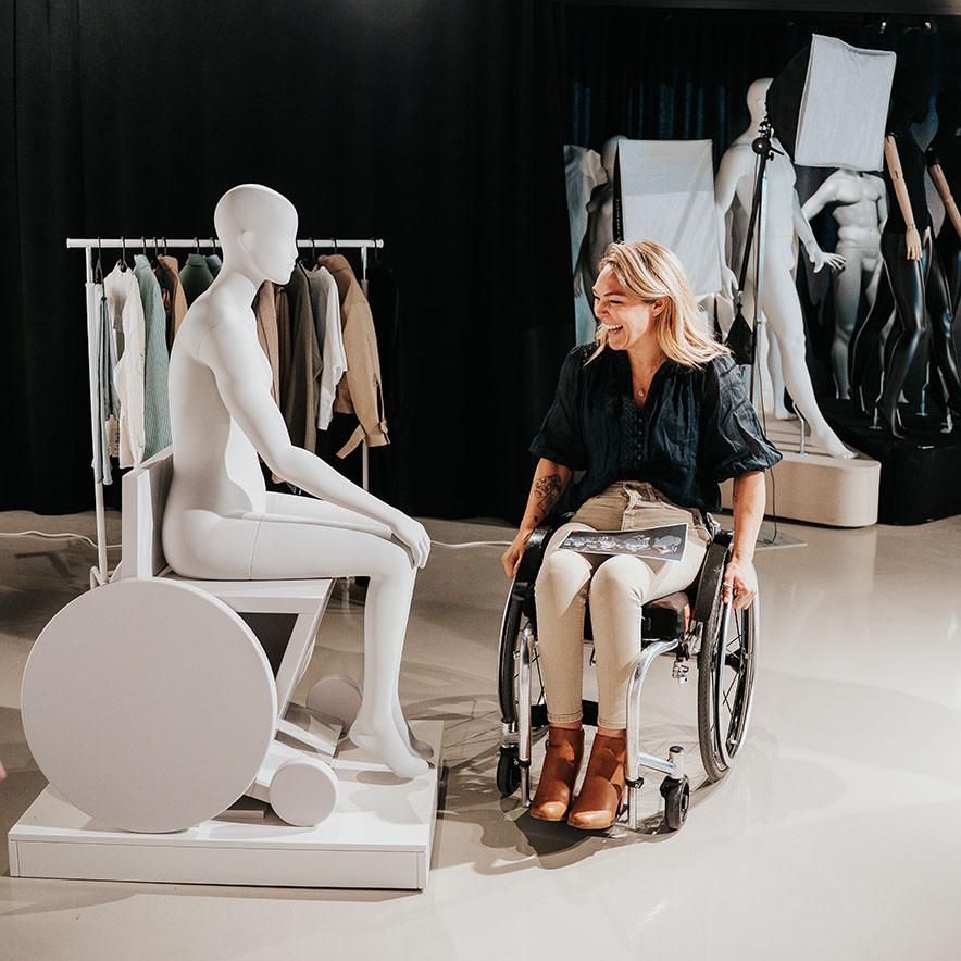 Disability advocate and wheelchair user, Sophie Morgan looking at The ‘Sophie’ mannequin.