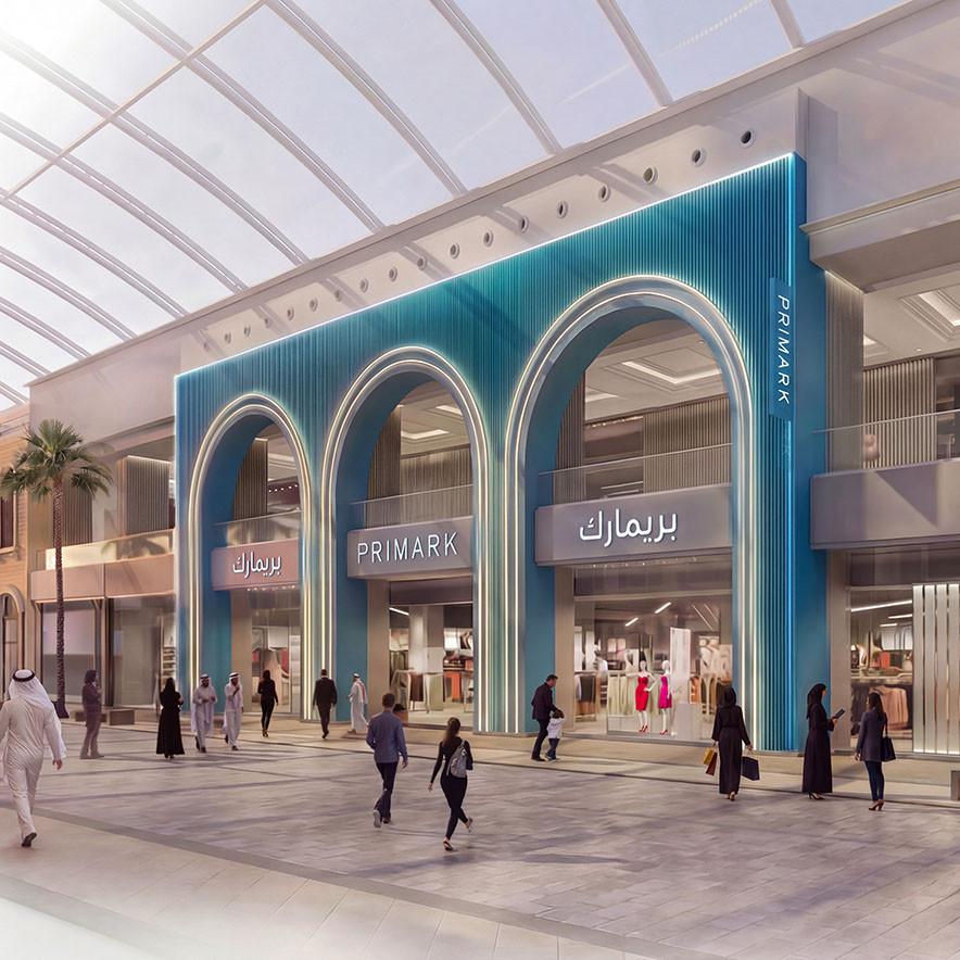 A modern Primark store entrance in a shopping mall with three large blue arched doorways.