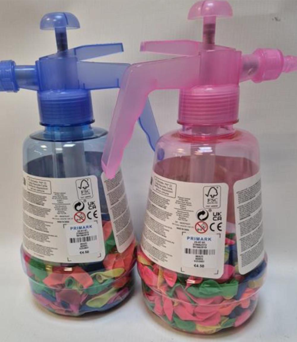 Primark water spray bottles in blue and pink, filled with colourful water balloons at the bottom.