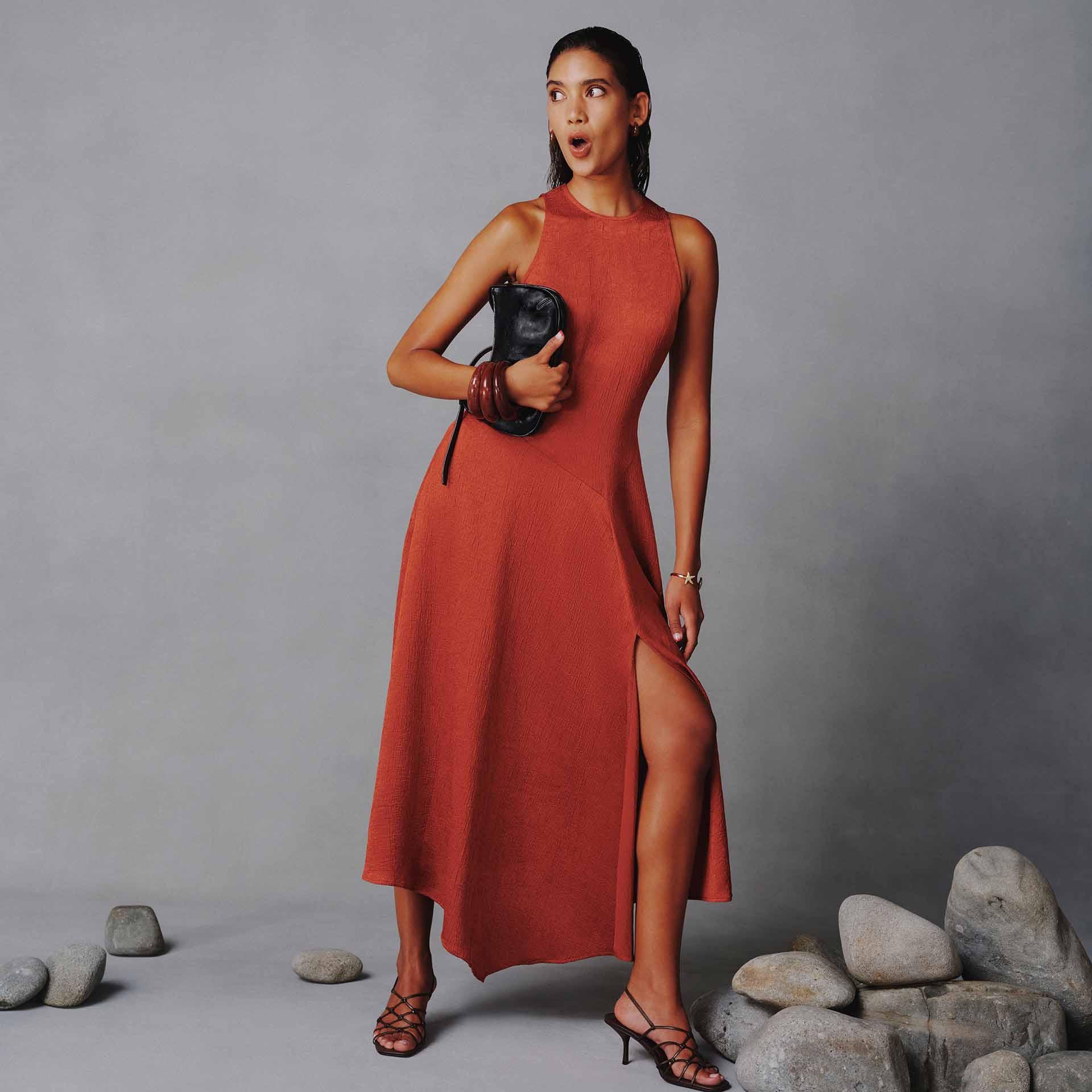 Women wearing a red dress with a surprised expression, on a neutral background.