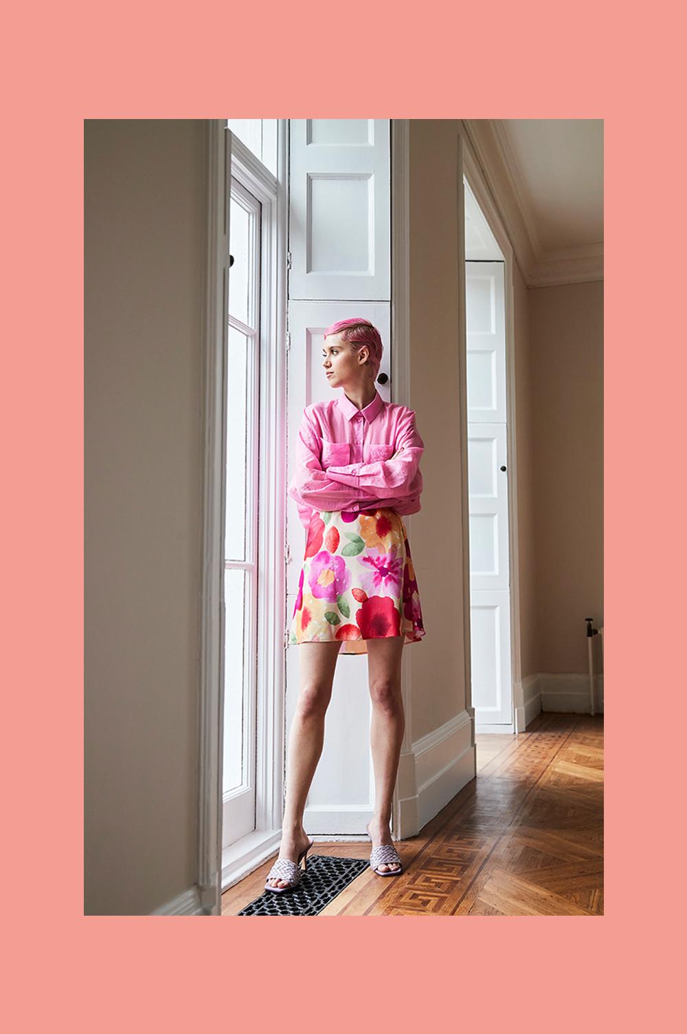 Model wearing pink shirt and floral dress