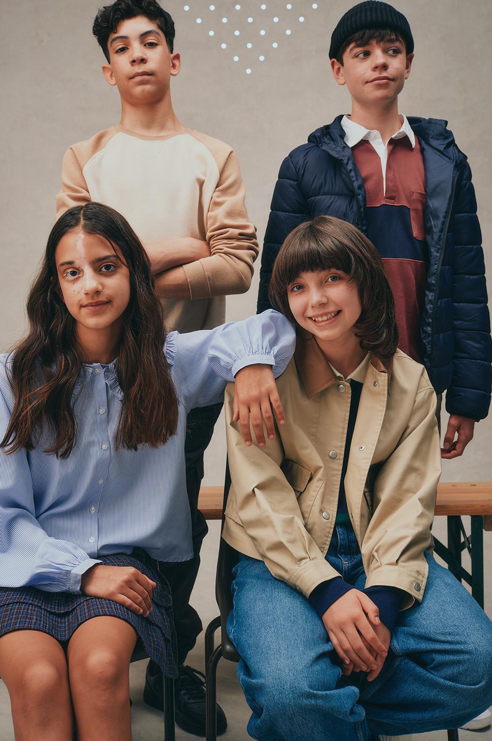 Children modeling casual fall fashion including sweatshirts, a navy puffer jacket, and beige jacket.