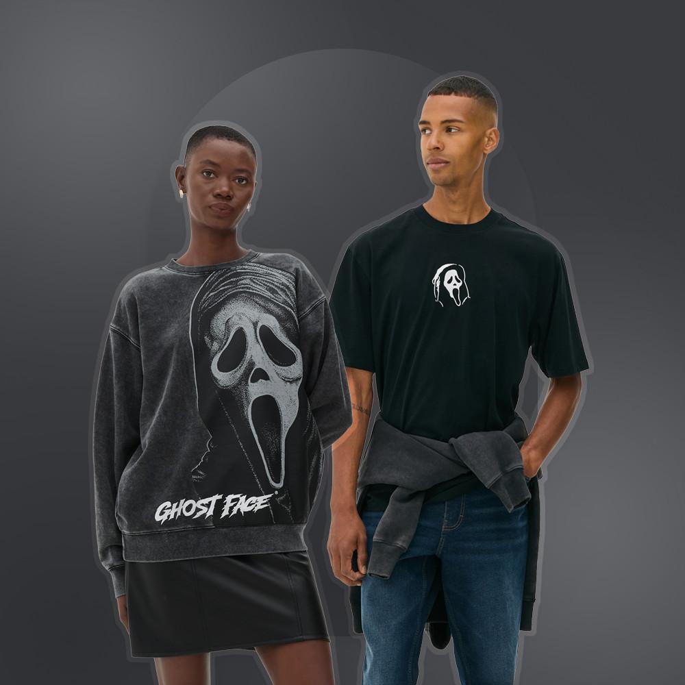 Two models wearing Ghostface movie merchandise - grey sweatshirt with mask graphic and black t-shirt with logo.