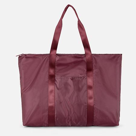Burgundy nylon tote bag with dual handles and front slip pocket with zip closure.