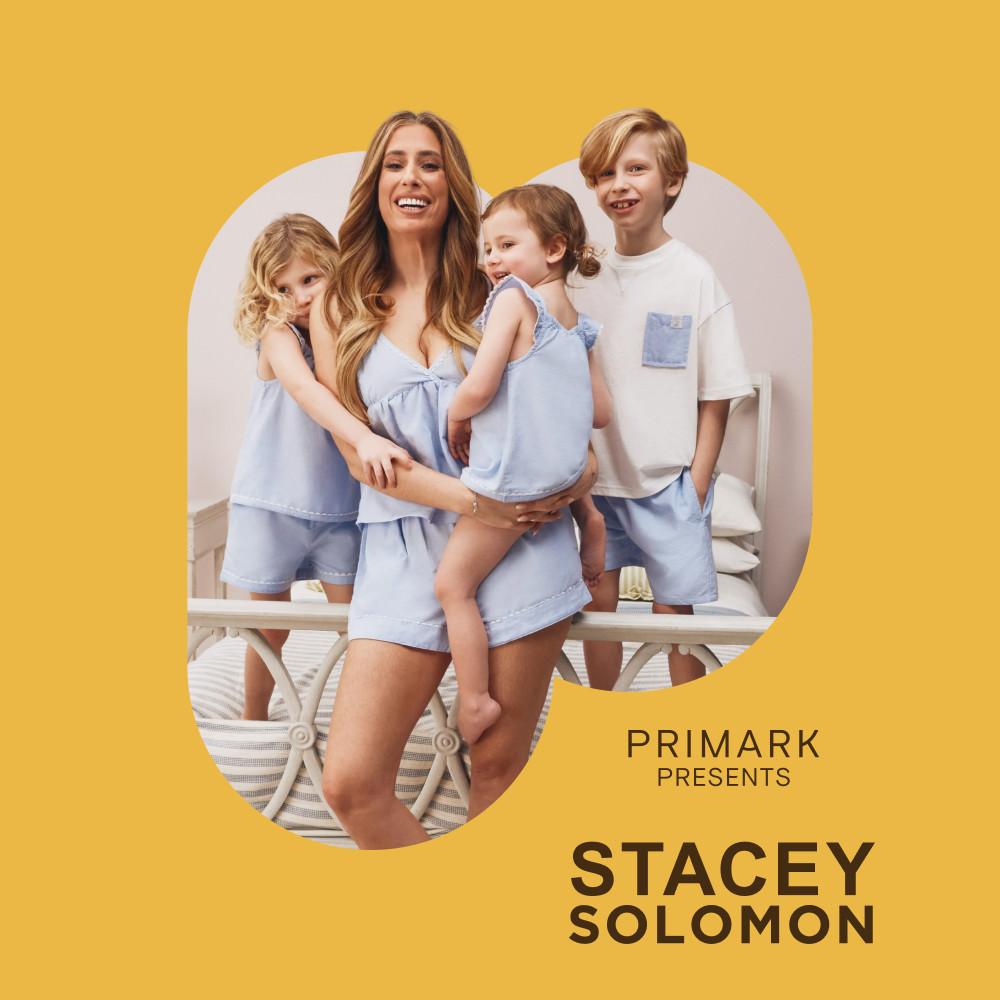 Family wearing matching light blue loungewear from Primark's Stacey Solomon collection against yellow background.