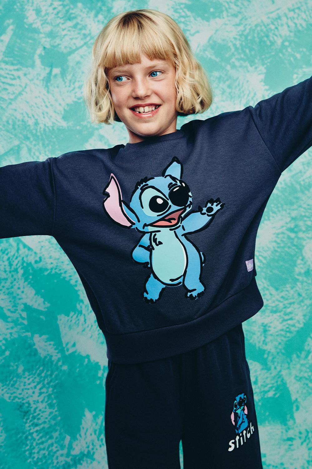 Child in Stitch sweatshirt, joggers