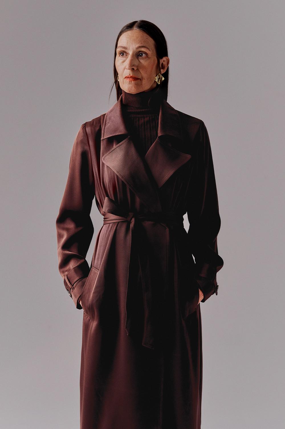 Model wears satin chocolate brown duster coat