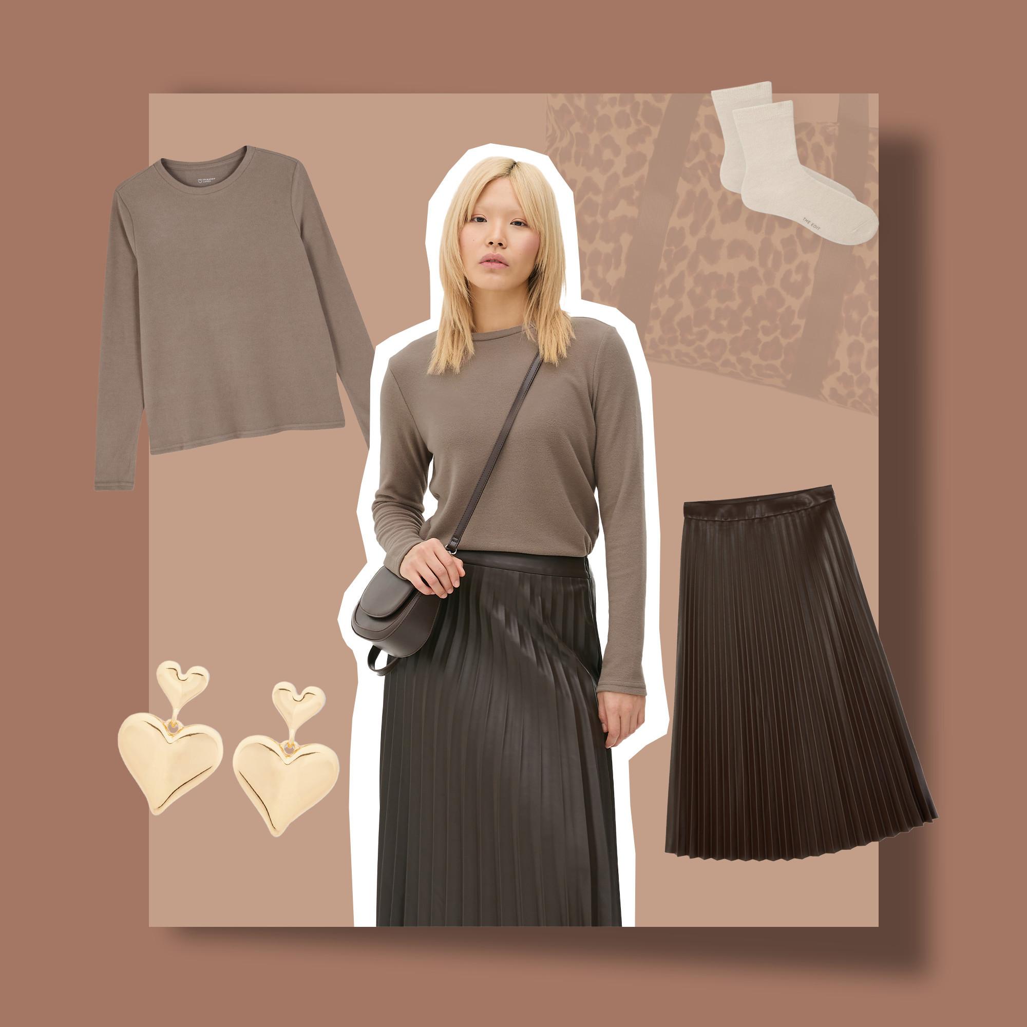 Model wearing a taupe top, pleated skirt and crossbody bag. Features gold tone heart earrings and socks.