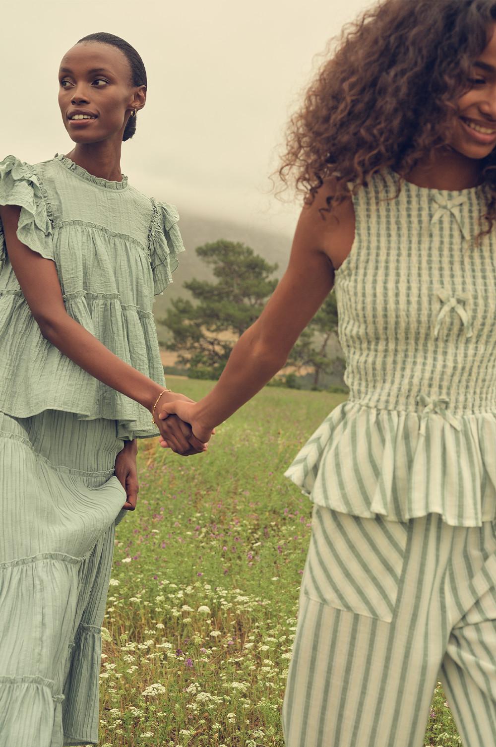 Parent and child wearing a striped co-ord and pastel green co-ord