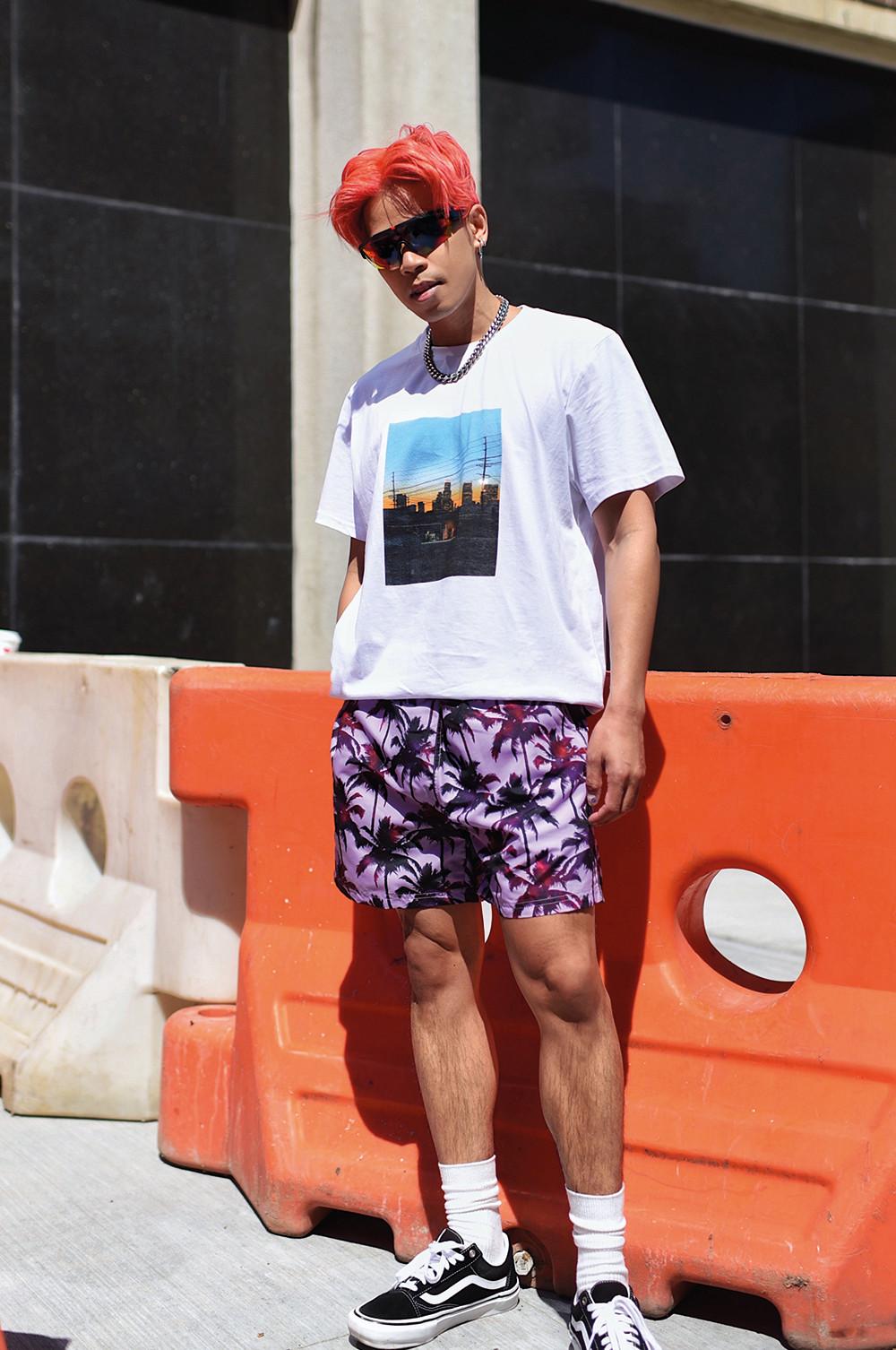 Model wearing printed tee and statement shorts