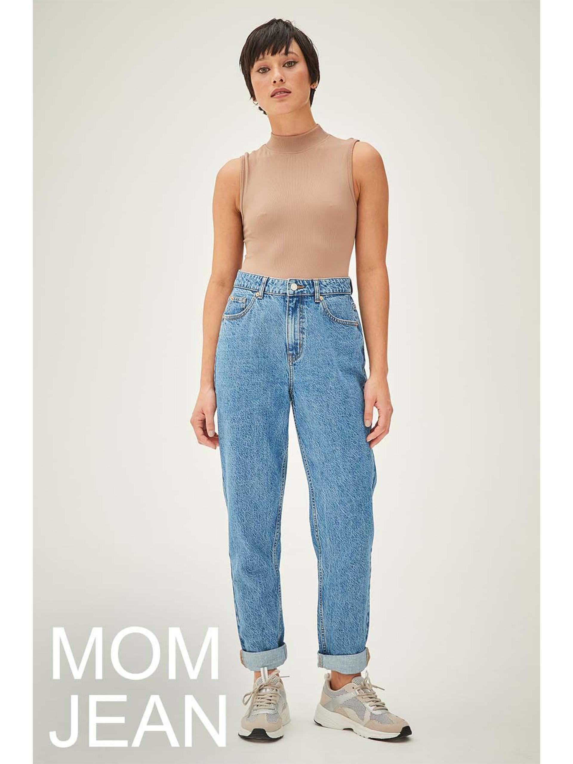 Model wears blue denim Mom Jeans