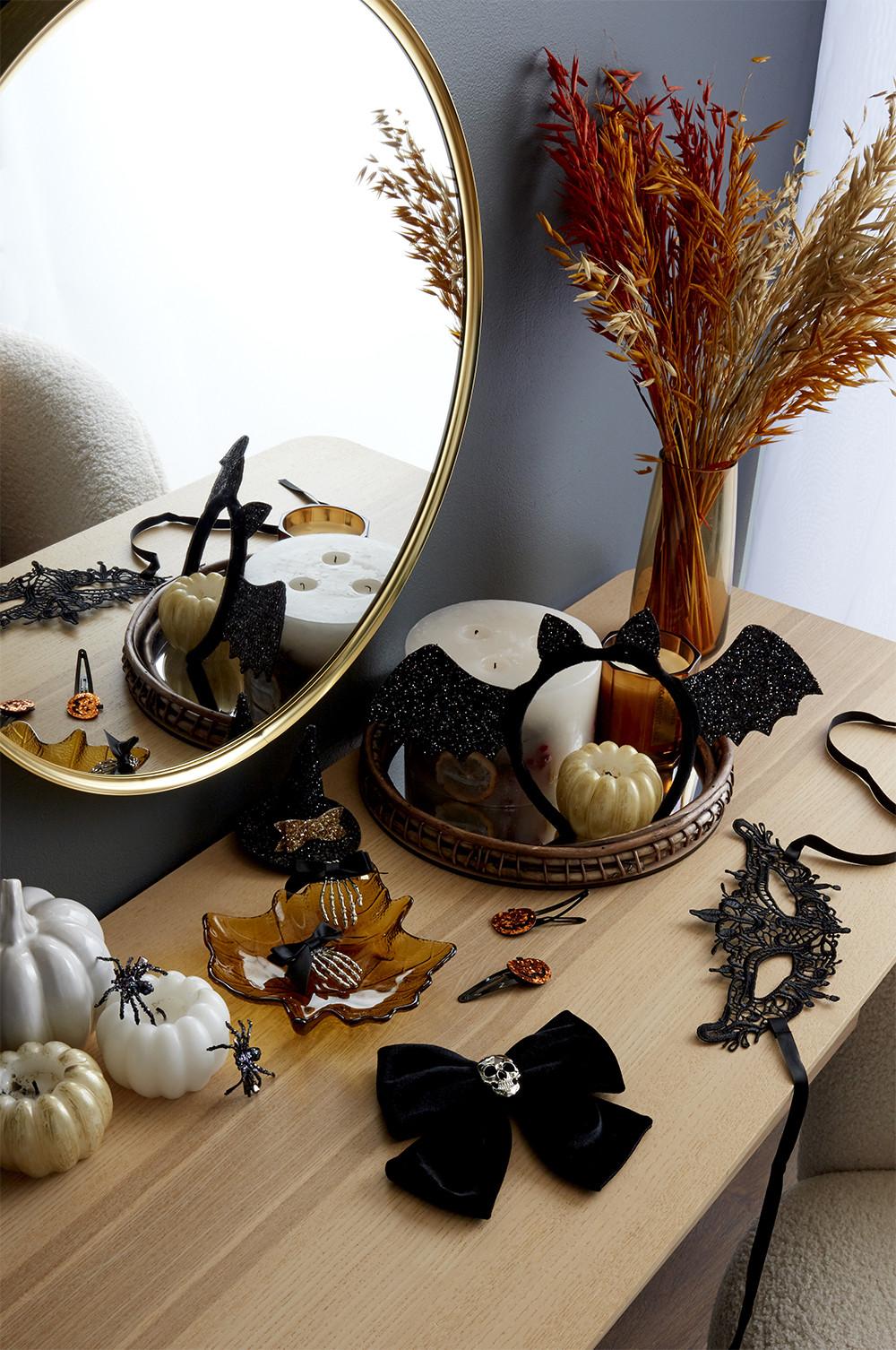 flat lay of halloween accessories, like masks, cat ears and bat headbands