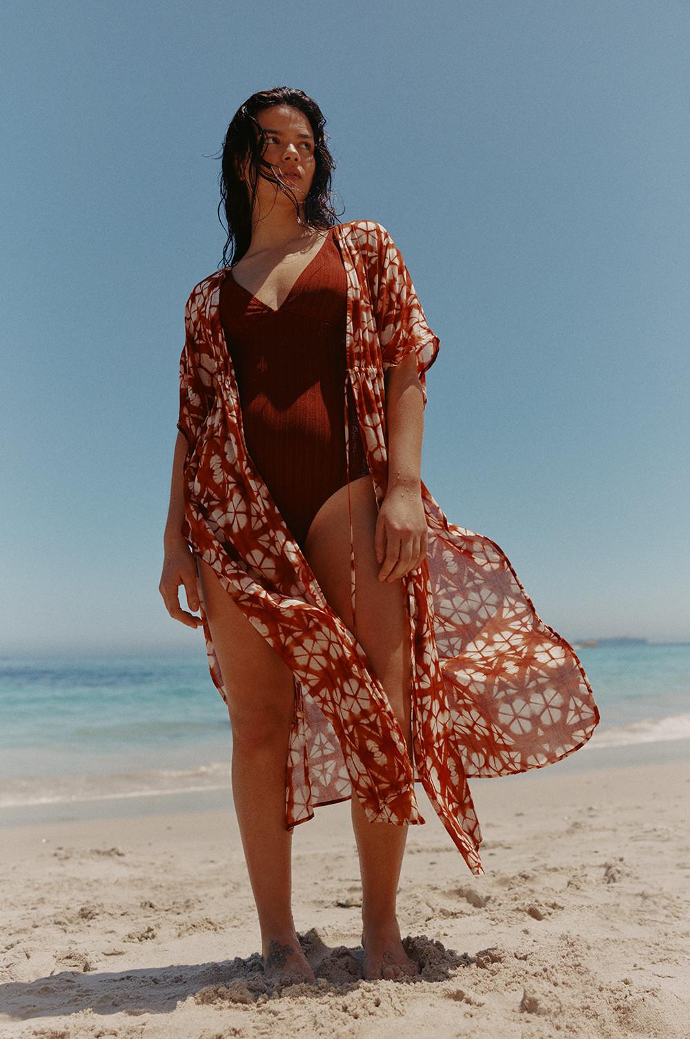 Modelo con traje de baño en color óxido y kimono con estampado