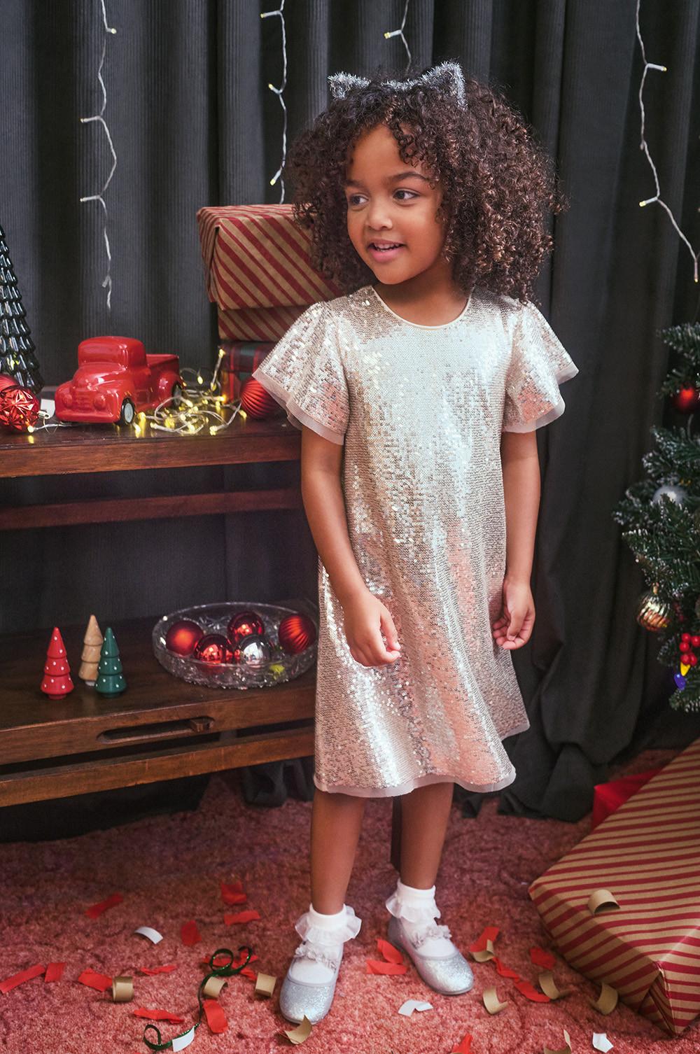 Child wears silver sequin dress