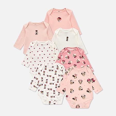 Collection of seven baby bodysuits featuring Minnie Mouse designs in pink, white and cream colours.