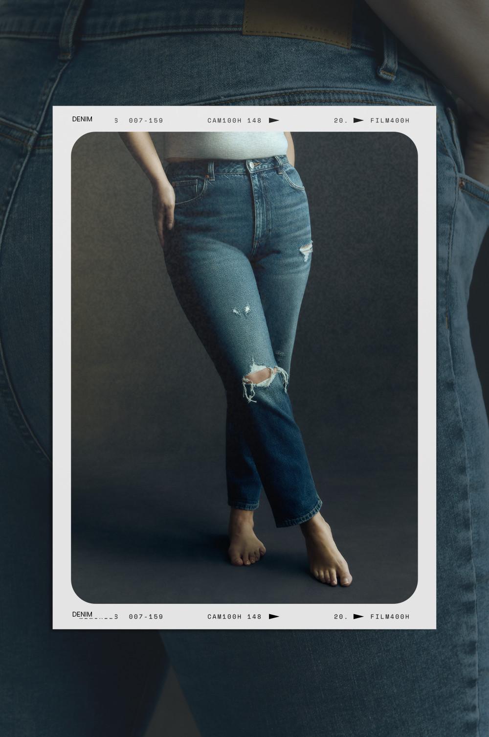 Distressed blue jeans with ripped knees on model against dark backdrop, Polaroid-style frame.