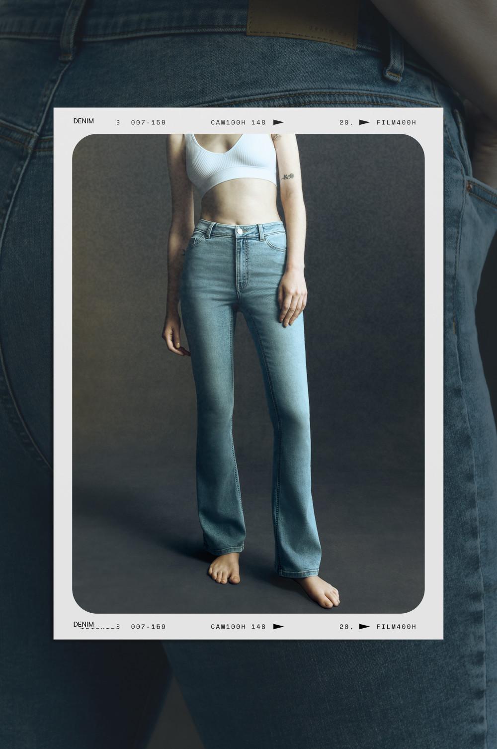 Light wash flared denim jeans on model with white crop top, in film-style frame format.