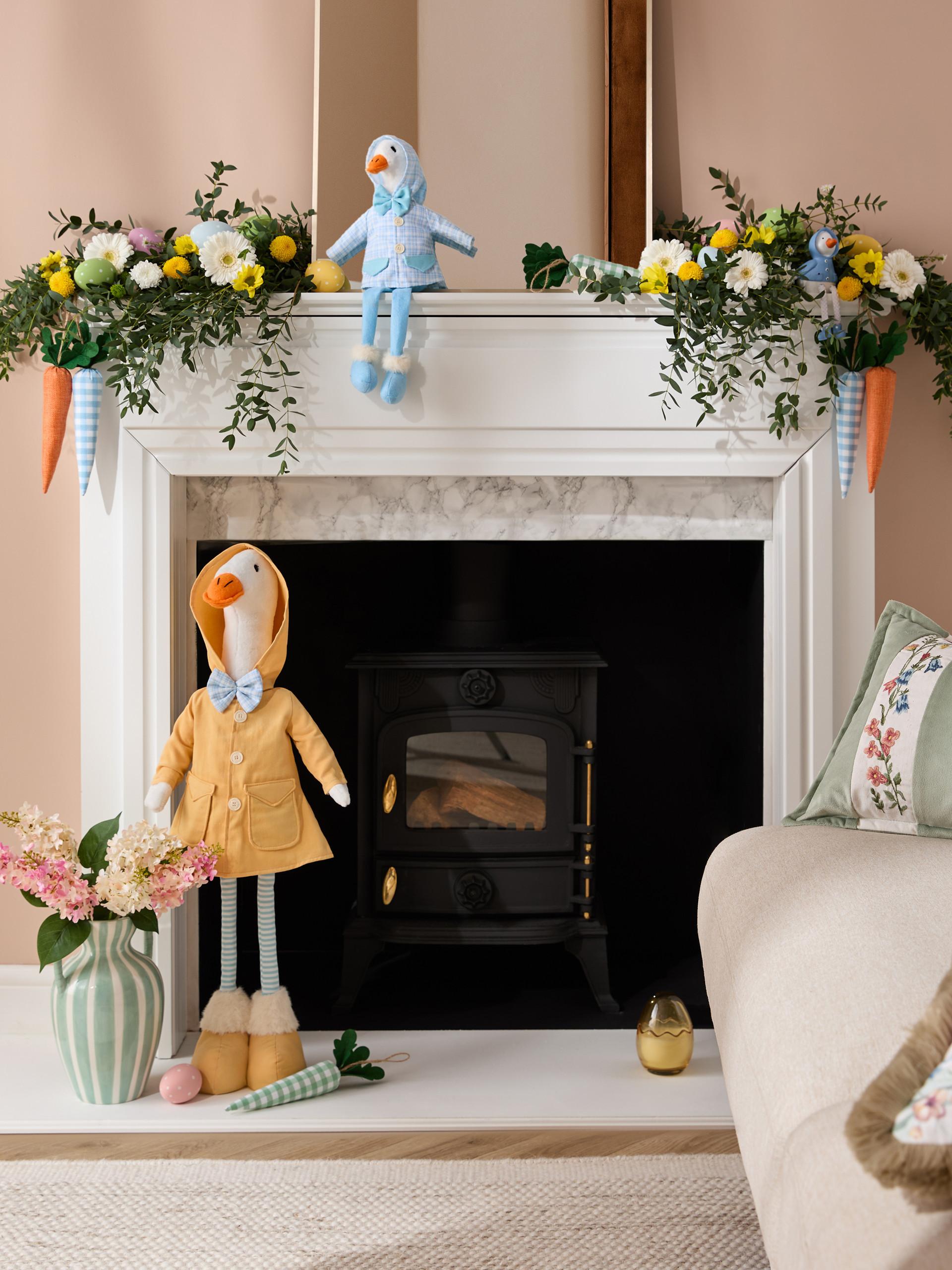 Child wearing cream striped button-up shirt over white t-shirt with blue jeans against pink background.