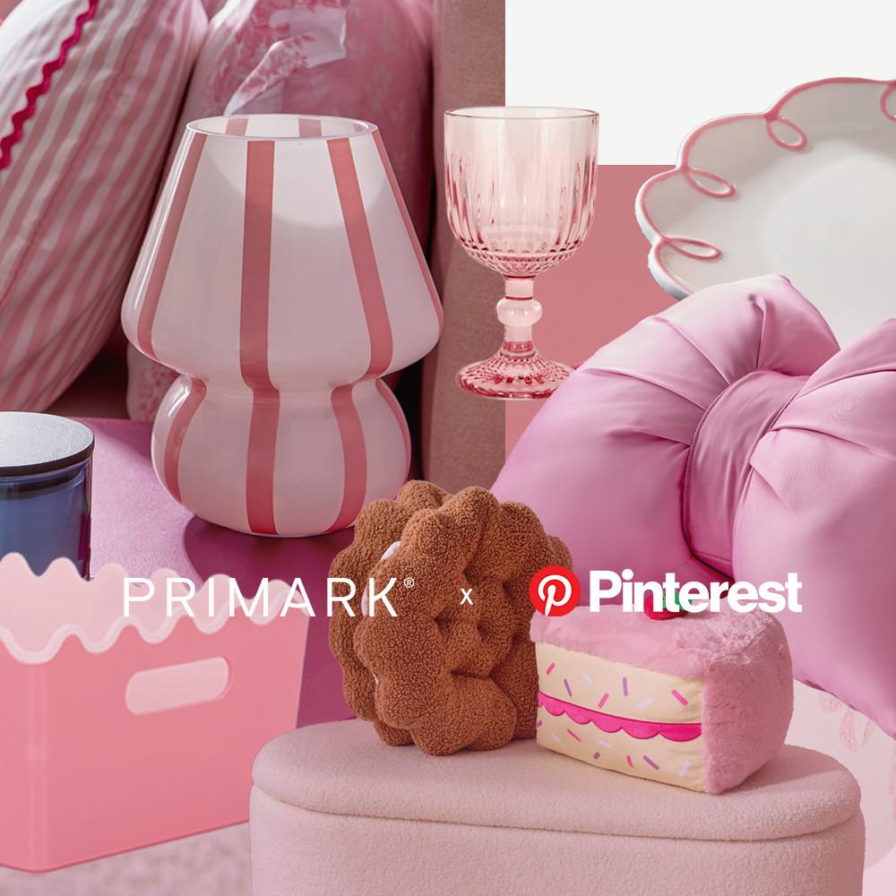 Homeware collage showing pink striped table lamp, crystal wine glass, white plate with pink edge detail, plush cookie cushion and cake cushion, pink storage box arranged with pink home accessories.