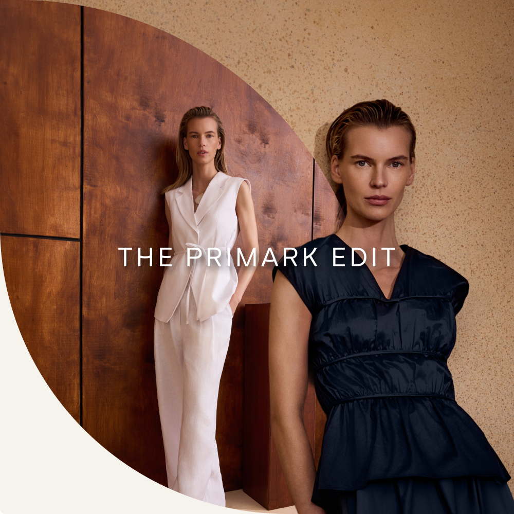 Two models wearing sleeveless tailored dresses, one in white and one in navy, for THE PRIMARK EDIT collection.
