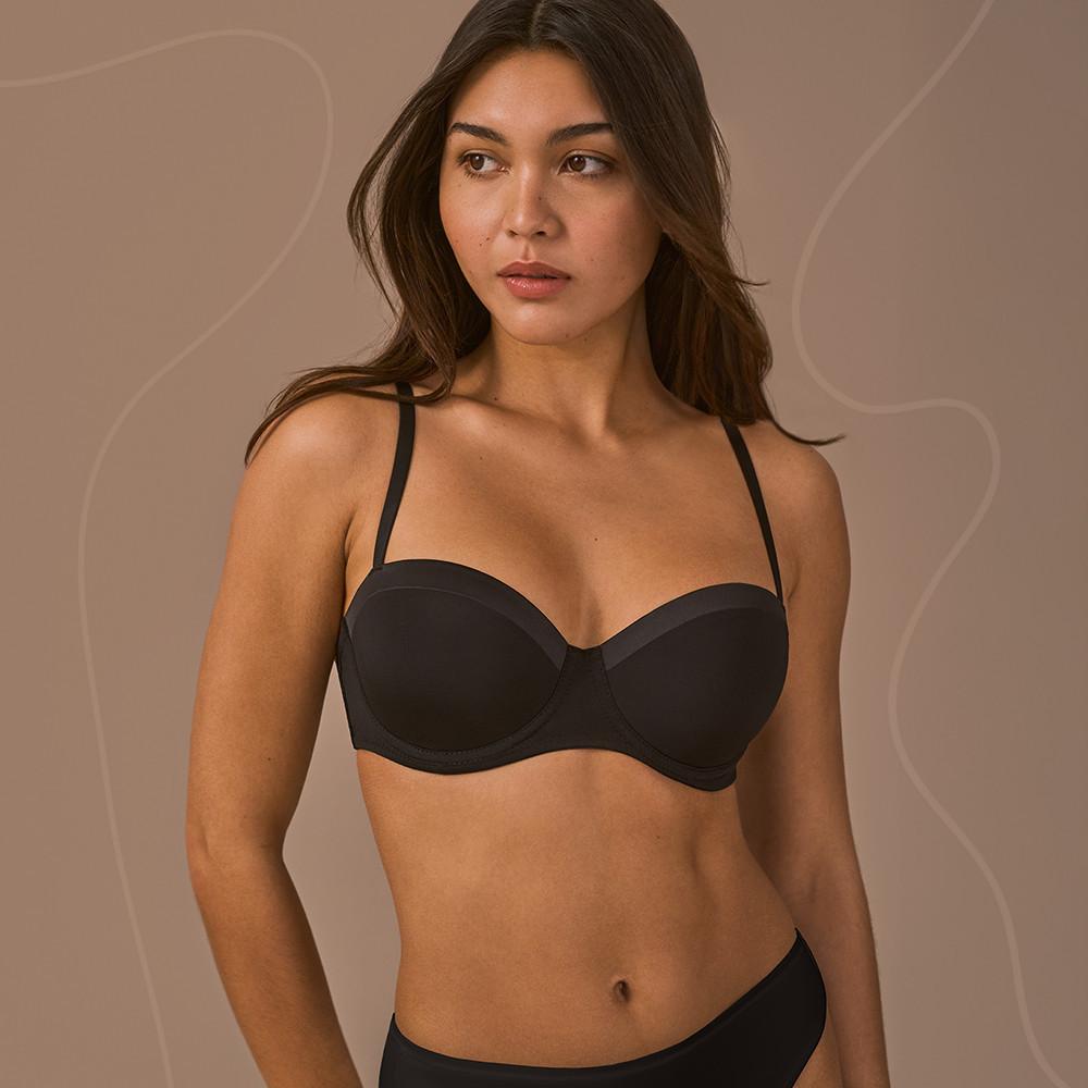 Model wearing a black bra and briefs
