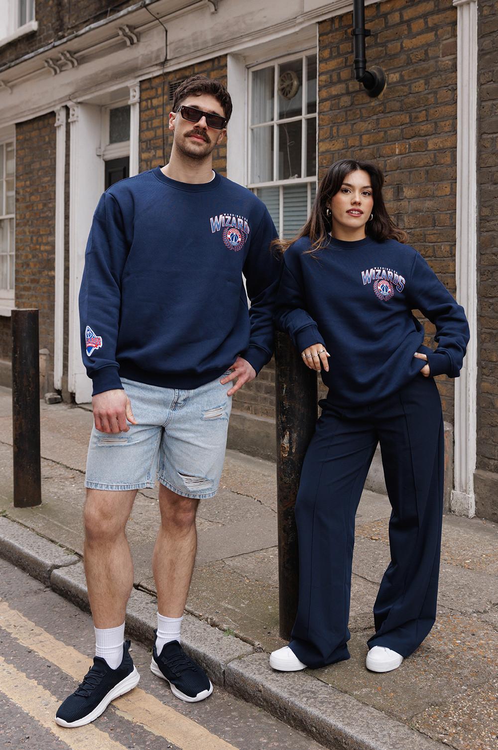 Models wearing navy Washington Wizards sweatshirts with trousers, shorts and trainers
