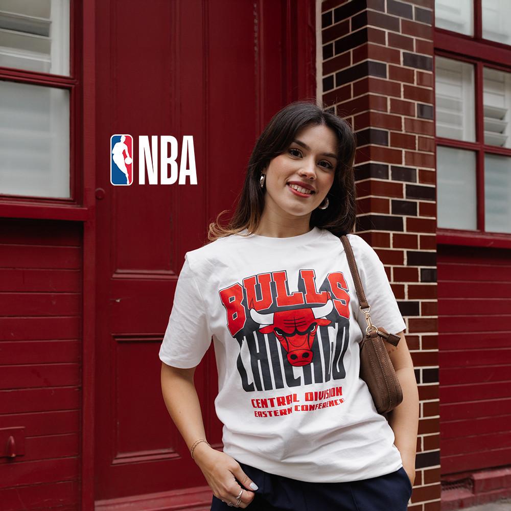Model wearing a white t-shirt with Bulls Chicago graphic on the front