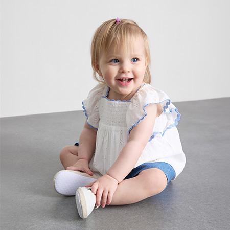 Pink and coral gingham two-piece set with ruffled straps, button-front top and matching shorts.
